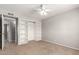 Bedroom boasts a ceiling fan and built-in shelving with a closet for ample storage space at 1829 E Decatur St, Mesa, AZ 85203