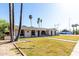 Charming single-story house featuring arched windows, well-maintained front yard with mature trees, and a welcoming entrance at 1829 E Decatur St, Mesa, AZ 85203