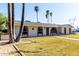 Charming single-story house featuring arched windows, well-maintained front yard with mature trees, and a welcoming entrance at 1829 E Decatur St, Mesa, AZ 85203