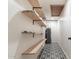 Functional hallway with floating shelves, patterned tile, and a water heater at 1829 E Decatur St, Mesa, AZ 85203