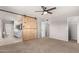 Bedroom with neutral carpet and view to the bathroom with a wood barn door at 1829 E Decatur St, Mesa, AZ 85203