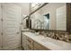 Elegant bathroom features dual sinks, decorative tile, and a large framed mirror at 2351 E Cherrywood Pl, Chandler, AZ 85249