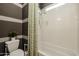 Clean bathroom with a toilet, shower, tub and striped wallpaper at 2351 E Cherrywood Pl, Chandler, AZ 85249