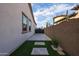 Long driveway leading to an iron gate, framed by a well-manicured yard at 2351 E Cherrywood Pl, Chandler, AZ 85249