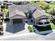 Striking aerial view of home with manicured landscaping and paver driveway, situated on a golf course at 2351 E Cherrywood Pl, Chandler, AZ 85249