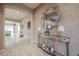 Elegant foyer featuring textured walls, a mirrored console table, and decorative lamps at 2351 E Cherrywood Pl, Chandler, AZ 85249