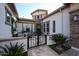 Charming front entrance with decorative iron gate, stone accents, and manicured landscaping at 2351 E Cherrywood Pl, Chandler, AZ 85249