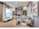 Sophisticated home office featuring custom built-ins, a glass desk, and a chaise lounge for relaxation at 2351 E Cherrywood Pl, Chandler, AZ 85249