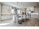 Spacious white kitchen boasts a center island with bar stool seating and pendant lighting above at 2351 E Cherrywood Pl, Chandler, AZ 85249