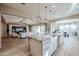 Open-concept kitchen with a farmhouse sink and stainless steel appliances leads to a dining and living area at 2351 E Cherrywood Pl, Chandler, AZ 85249