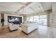 Bright and spacious living room with beamed ceilings, built-in shelving, and sliding glass doors at 2351 E Cherrywood Pl, Chandler, AZ 85249