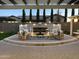 Inviting outdoor living space featuring a stone fireplace and elegant seating area at 2351 E Cherrywood Pl, Chandler, AZ 85249