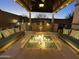 Cozy backyard with built-in outdoor kitchen, fire pit, and ample seating at 2351 E Cherrywood Pl, Chandler, AZ 85249