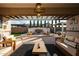 Covered patio with a fireplace, seating, and manicured greenery makes this perfect for entertaining at 2351 E Cherrywood Pl, Chandler, AZ 85249