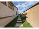 Well-maintained side yard with artificial turf and stone pathway at 2351 E Cherrywood Pl, Chandler, AZ 85249