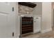 Elegant bar area features a built-in wine refrigerator and brick backsplash at 2552 E Silverwood Dr, Phoenix, AZ 85048
