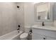 Clean bathroom with a tiled shower and tub combination, a modern vanity, and neutral decor at 2552 E Silverwood Dr, Phoenix, AZ 85048