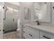 Bathroom showcasing a spacious vanity, a well-lit mirror, and an adjacent shower room featuring a glass partition at 2552 E Silverwood Dr, Phoenix, AZ 85048