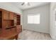 Bedroom with wood-look flooring, large window, and custom built-ins with shelving and drawers at 2552 E Silverwood Dr, Phoenix, AZ 85048