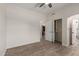 Bedroom includes modern wood-look flooring, closet doors, and an ensuite bath with an arched doorway at 2552 E Silverwood Dr, Phoenix, AZ 85048
