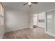 Versatile bedroom or office space with new hard wood flooring, a ceiling fan, and ample natural light at 2552 E Silverwood Dr, Phoenix, AZ 85048