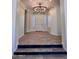 Inviting entryway featuring wood-look floors, stylish lighting, and a classic white front door with sidelights at 2552 E Silverwood Dr, Phoenix, AZ 85048