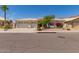 Single-story home showcasing desert landscaping, a well-manicured lawn, and a beige exterior with a tile roof at 2552 E Silverwood Dr, Phoenix, AZ 85048