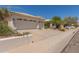 Single-story home featuring a three-car garage, a beige exterior, and desert landscaping at 2552 E Silverwood Dr, Phoenix, AZ 85048