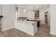 Bright kitchen featuring white cabinets, stone backsplash, and a dark wood center island at 2552 E Silverwood Dr, Phoenix, AZ 85048