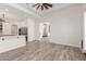 Open floor plan with kitchen, dining, and living area with wood-style flooring and natural light at 2552 E Silverwood Dr, Phoenix, AZ 85048