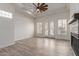 Bright living room featuring wood-look floors, a fireplace, and natural light from the windows at 2552 E Silverwood Dr, Phoenix, AZ 85048