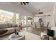 Staged living room with a view of the fireplace and backyard swimming pool at 2552 E Silverwood Dr, Phoenix, AZ 85048