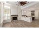 Open living space with wood-style floors, a brick fireplace, and a view into the kitchen at 2552 E Silverwood Dr, Phoenix, AZ 85048
