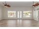 Bright living room boasts expansive windows overlooking the refreshing backyard pool at 2552 E Silverwood Dr, Phoenix, AZ 85048