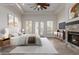 Staged main bedroom with a fireplace, tray ceiling, and natural light from shuttered windows at 2552 E Silverwood Dr, Phoenix, AZ 85048