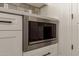 Close-up of stainless-steel microwave installed in the kitchen's white cabinetry at 2552 E Silverwood Dr, Phoenix, AZ 85048