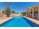 Sparkling backyard pool with beautiful desert landscaping and an adjacent manicured lawn at 2552 E Silverwood Dr, Phoenix, AZ 85048