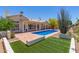 Backyard pool with artificial turf and desert landscaping at 2552 E Silverwood Dr, Phoenix, AZ 85048