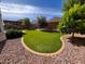 Beautiful landscaped backyard with an outdoor dining area, pergola and trees at 25935 W Potter Dr, Buckeye, AZ 85396