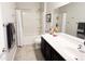 Bright bathroom featuring a single sink vanity, toilet, shower, and a shower/tub combination at 25935 W Potter Dr, Buckeye, AZ 85396
