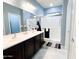 Beautiful bathroom with dual sinks, a large mirror, and a glass-enclosed shower at 25935 W Potter Dr, Buckeye, AZ 85396