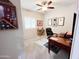 Comfortable bedroom features a large window, desk and ceiling fan at 25935 W Potter Dr, Buckeye, AZ 85396
