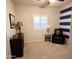 Neutral toned bedroom with a window and chair, offering a serene and relaxing space at 25935 W Potter Dr, Buckeye, AZ 85396