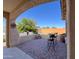 Inviting covered patio with a charming bistro set and a beautiful view of the surrounding neighborhood at 25935 W Potter Dr, Buckeye, AZ 85396
