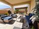 Inviting covered patio with an outdoor seating area and view of backyard with a pergola and barbecue at 25935 W Potter Dr, Buckeye, AZ 85396