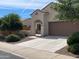 Exterior view of a well-maintained home with a neatly landscaped yard and a spacious driveway at 25935 W Potter Dr, Buckeye, AZ 85396