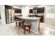 Modern kitchen featuring a stainless steel refrigerator and a large granite island at 25935 W Potter Dr, Buckeye, AZ 85396