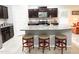 Kitchen featuring an island with seating and stainless steel appliances at 25935 W Potter Dr, Buckeye, AZ 85396
