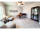 Cozy living room with piano, chairs, and display case at 25935 W Potter Dr, Buckeye, AZ 85396