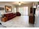 Cozy living room with tile floors, a ceiling fan, and access to the backyard at 25935 W Potter Dr, Buckeye, AZ 85396